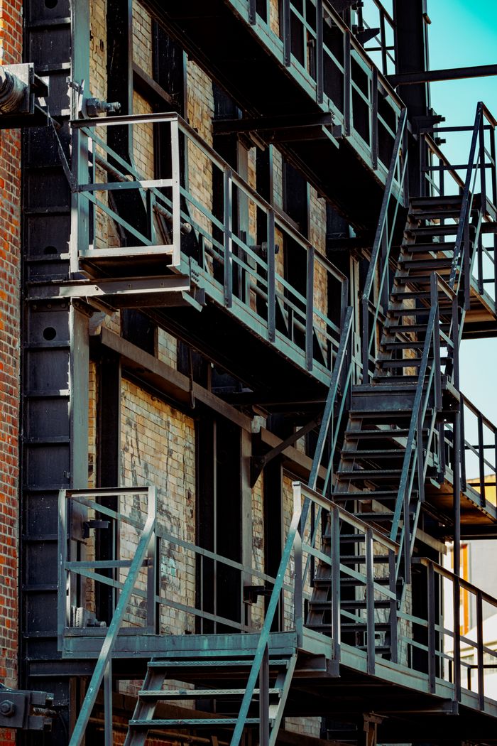 Close-up of a metal fire escape structure on a brick building facade in Istanbul, Turkey.