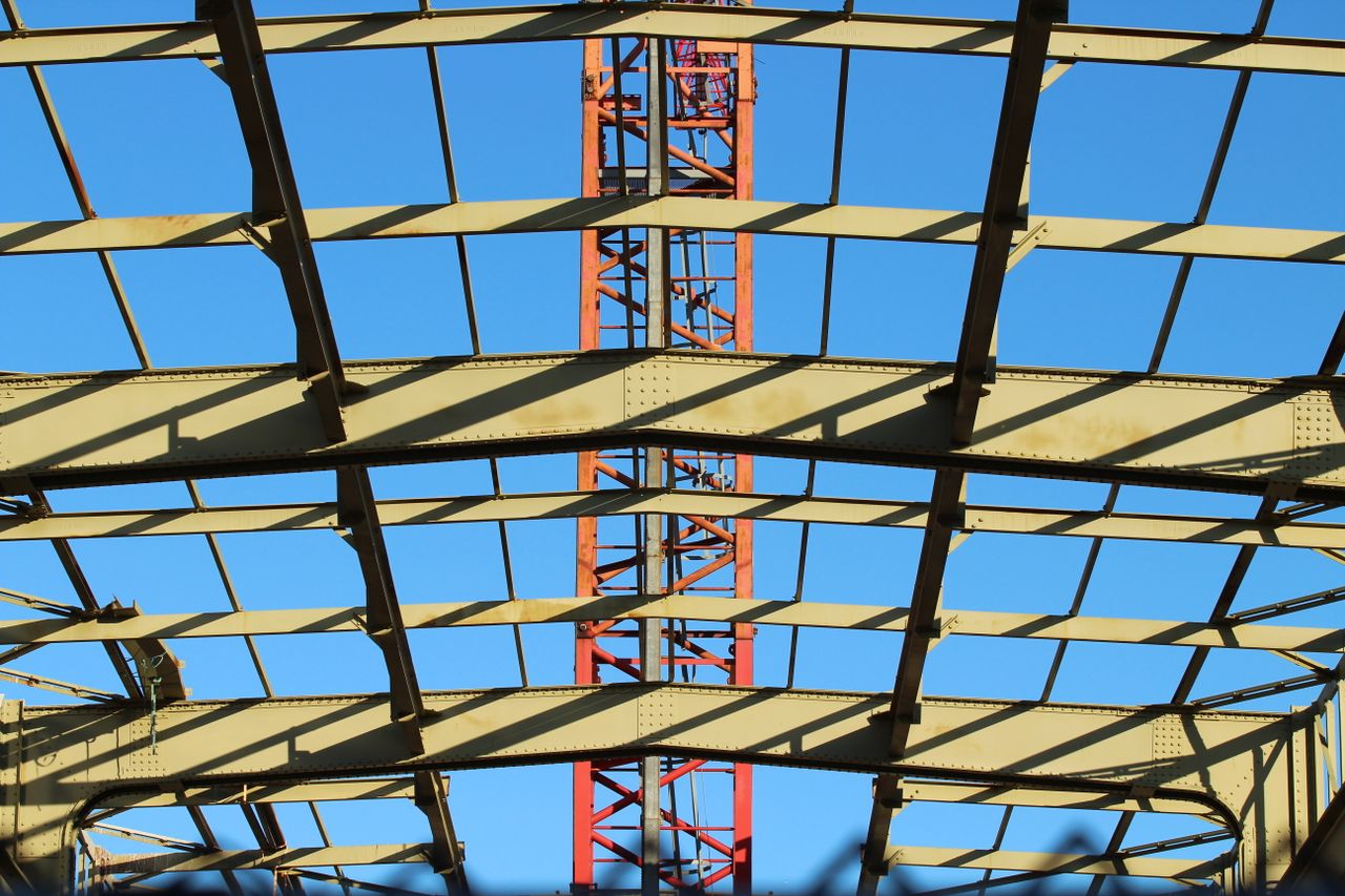 View of a steel construction framework under clear blue sky in the Netherlands.
